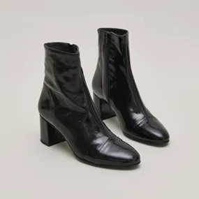 Heeled boots in black pleated patent